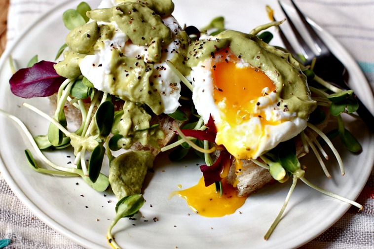 Poached eggs on Sourdough toast with avocado sauce via @danielleomar