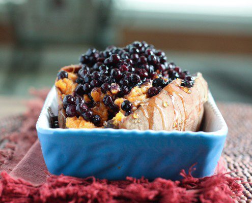 Warm Wild Blueberries poured over a twice Baked Sweet Potato -- so decadent and so delicious! Perfect healthy holiday side dish recipe or weeknight dinner!